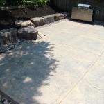 A decorative concrete patio, coloured, with a textured finish.